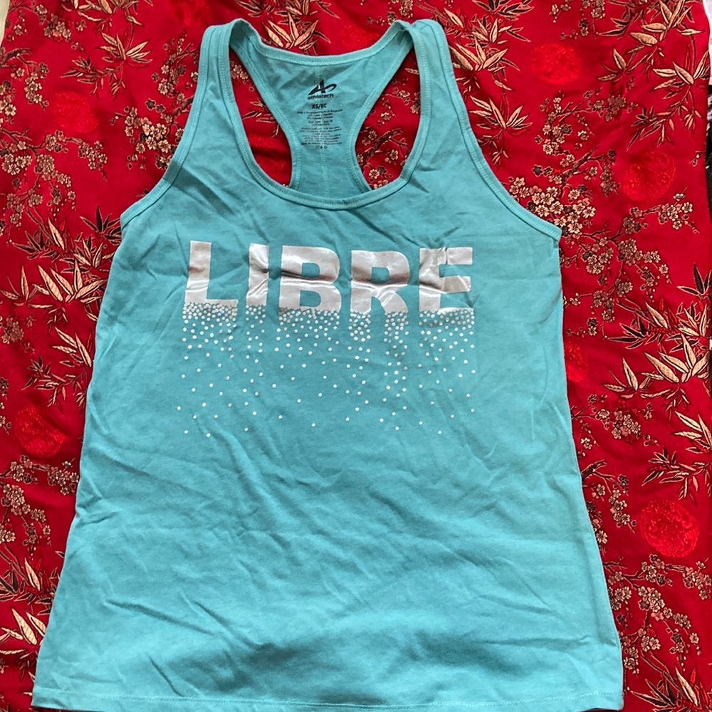 Racer back tank. Silver letters: L I B R E